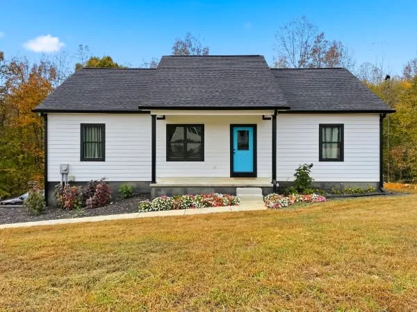 White cottage with bright blue front door